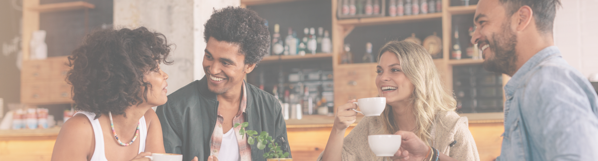 People sat at a table smiling and chatting