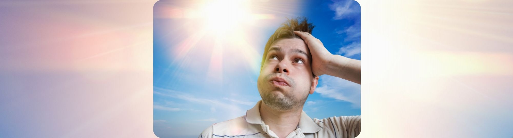 Photo of a man under hot sun,blowing his cheeks and ruffling his hair. He looks hot and uncomfortable.